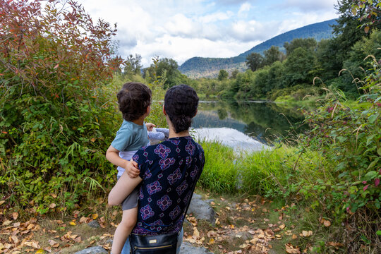 Mother Holding Young Son Looking Over Lake at Great Blue Heron Nature Reserve in Chilliwack BC Canada