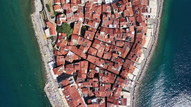 Top-down aerial view of red-tiled roofs on Piran peninsula, Slovenia