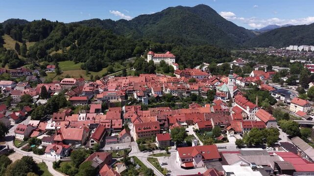 Aerial overview of Skofja Loka town center and hilltop castle, Slovenia