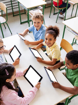 Generation alpha children using digital tablets at school