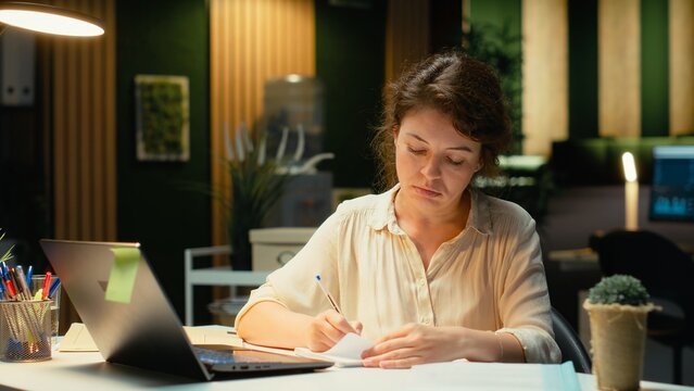 Businesswoman tears paper after making a mistake at work