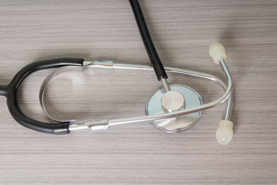 Stethoscope on a gray background; equipment for doctors, nurses, veterinarians, and healthcare professionals in general.