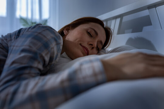 Woman sleeping in bed during night