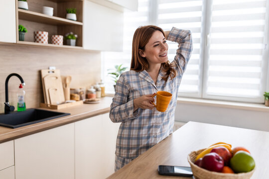 Woman enjoys morning coffee in a bright kitchen