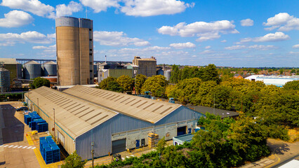aerial view of industrial warehouse building with tall tower silo © Андрей Нелупов