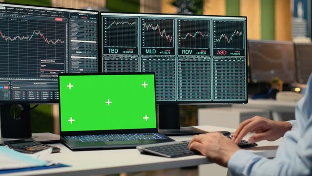 Day trader analyzes stock charts on isolated screen laptop