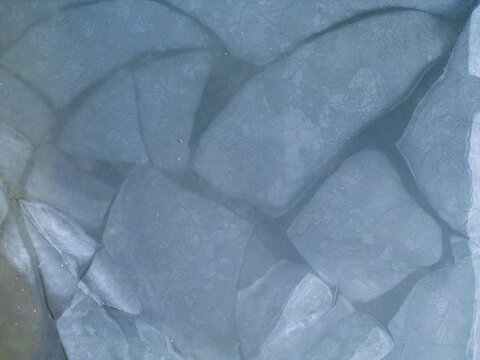 Aerial view of ice patterns on a frozen lake surface in Parco Nazionale dell'Appennino Tosco-Emiliano, Provincia di Massa e Carrara, Italy.
