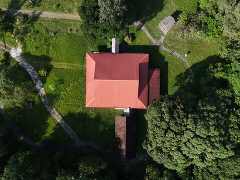 Aerial drone view of the Maison de la Nature at Pripri de Yiyi, surrounded by tropical vegetation and waterways in French Guiana, South America.