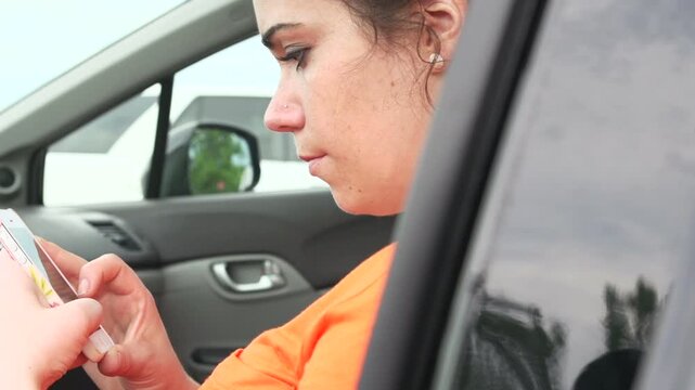 Female on cell phone in car slider shot
