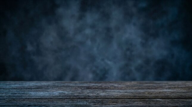 A rustic wooden table surface sits against a dark moody blue textured background with swirling fog. Ideal for product displays, spooky background design, and holiday promotional banners.