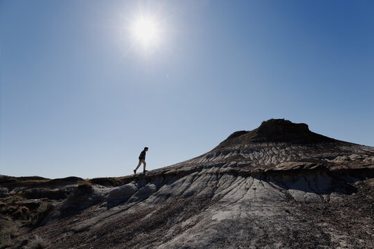 Young boy hiking up a hill in the badlands