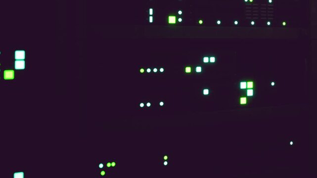 A server rack is present in a data center. It has several green lights indicating the active status of various network devices. This scene shows the technology used for data storage and networking.