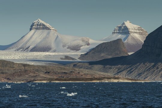 A fjord with ice floes and two of the three mountains: Tee Kroner (Three Crowns), Kronebreen or Kronengletscher Glacier, Kongsfjord or Kongsfjorden, the Svalbard archipelago, Svalbard, Norway