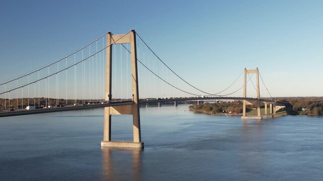 Aerial footage of the New Little Belt suspension bridge crossing calm blue water between Jutland and Funen near Middelfart and Fredericia, Denmark.