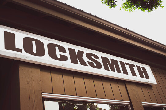 Old worn locksmith sign on building