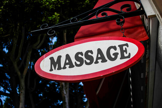 Old red vintage massage sign on building