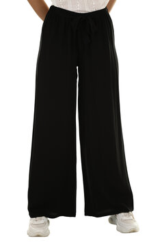 Woman wearing pants in a white studio for e-commerce fashion