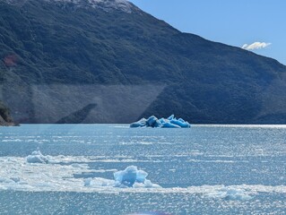 Floating Ice Fragments on Turquoise Glacial Lake in Patagonia © Nataliia