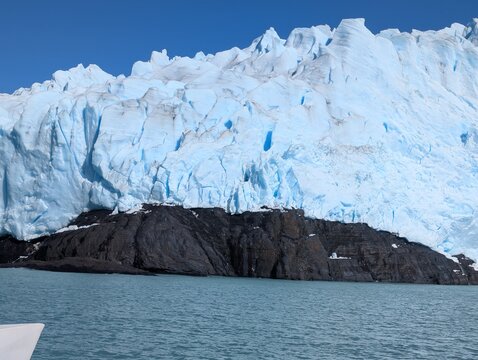 Jagged Blue Glacier Front With Dark Rock Outcrop in Patagonia