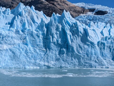 Crevassed Blue Glacier Front and Turquoise Water Close View