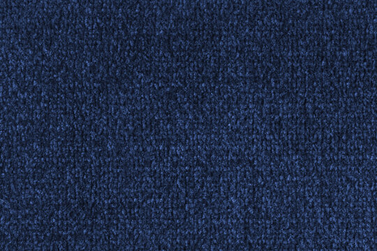 Close up, macro of blue fabric texture with soft velvet, fluffy woven surface, microfiber textile detail. Knitted jersey cloth background, backdrop, wallpaper for design, fashion or interior
