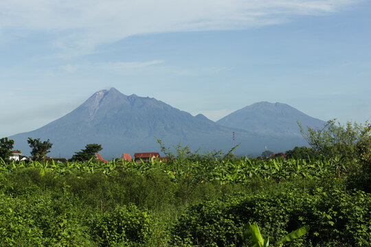 A beautiful view of Mount Merapi and Mount Merbabu on a clear morning.