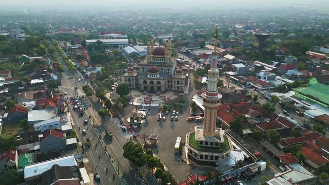 Aerial view of Al Aqsha Great Mosque surrounded by urban buildings and roads in Kecamatan Klaten Utara, Jawa Tengah, Indonesia.