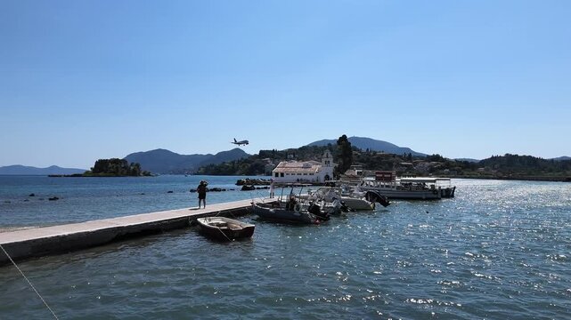 4K 240fps slow motion shot of a Ryanair plane flying low over the Holy Monastery of Panagia Vlacherna