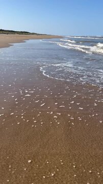 Waves breaking and rolling up the beach at Mablethorpe in Lincolnshire, UK