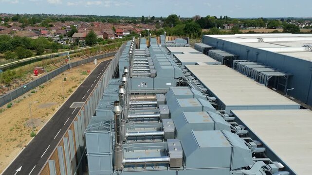 Aerial view of a hyperscale data center featuring rows of external cooling units and server room chillers in Waltham Cross, England, United Kingdom.