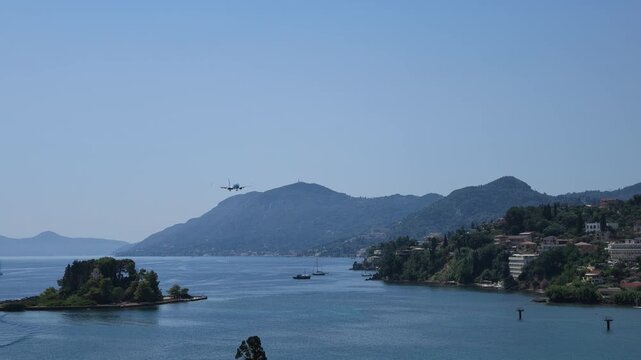 4K shot capturing a TUI passenger plane landing at Corfu Airport, Greece, over the iconic turquoise waters and planespotting area
