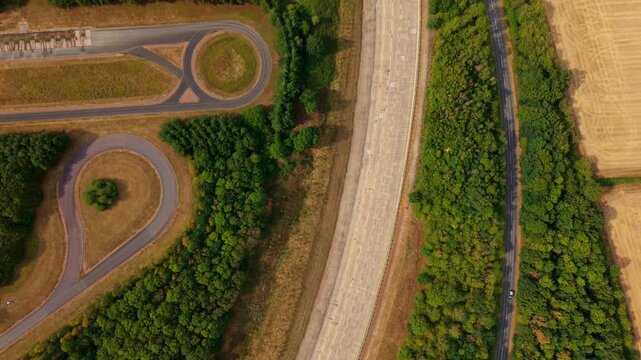 Aerial view of Millbrook Proving Ground featuring test tracks surrounded by dense woodland and agricultural fields in Bedford, England, United Kingdom.