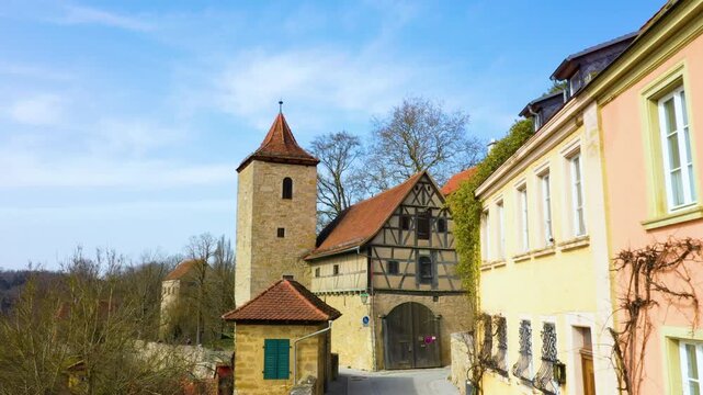 4K view of a historic stone tower, half-timbered building and traditional architecture in Rothenburg ob der Tauber, Bavaria, Germany.