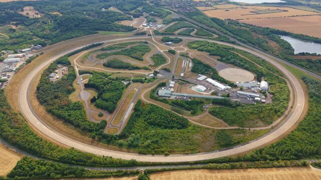 Aerial view of Millbrook Proving Ground featuring the circular test track and surrounding woodland in Bedford, England, United Kingdom.