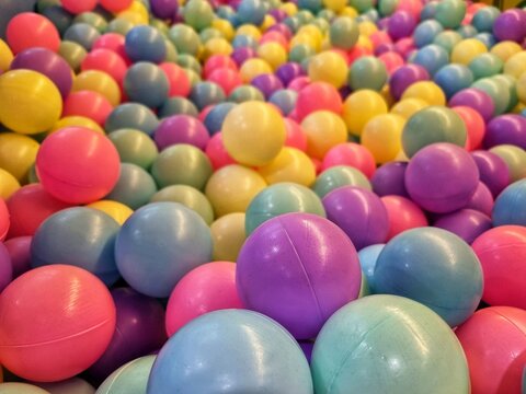A vibrant ball pit filled with countless colorful plastic balls, makes for a fun filled play area for children