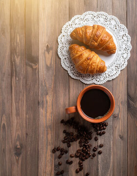 Croissant coffee pastry wooden table breakfast plate croissant coffee pastry wooden table breakfast plate with warm sunlight, scattered coffee bean, and inviting morning arrangement