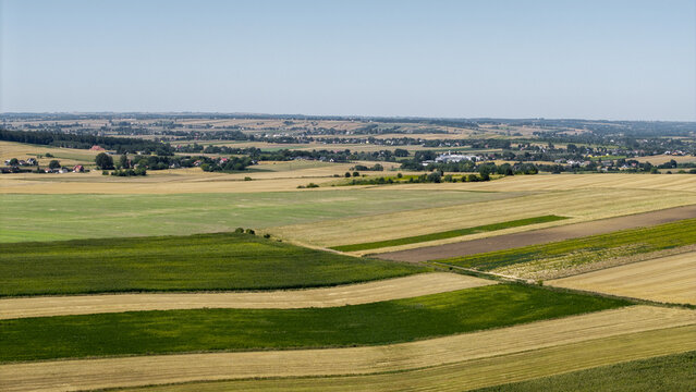 Aerial view of agricultural fields and crops during harvest season in Poland.