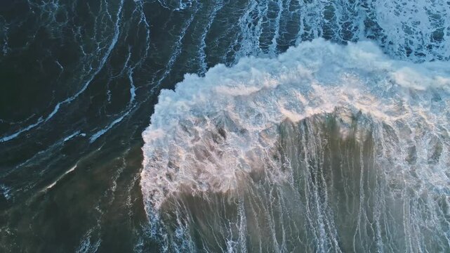 Aerial view of large wave breaking in the Atlantic Ocean near the coast in Nazare, Leiria District, Portugal.