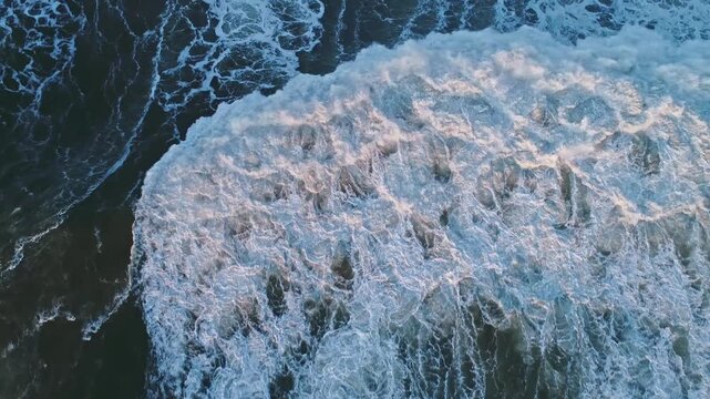Aerial view of a massive breaking wave crashing into the Atlantic Ocean off the coast of Nazare, Leiria District, Portugal.