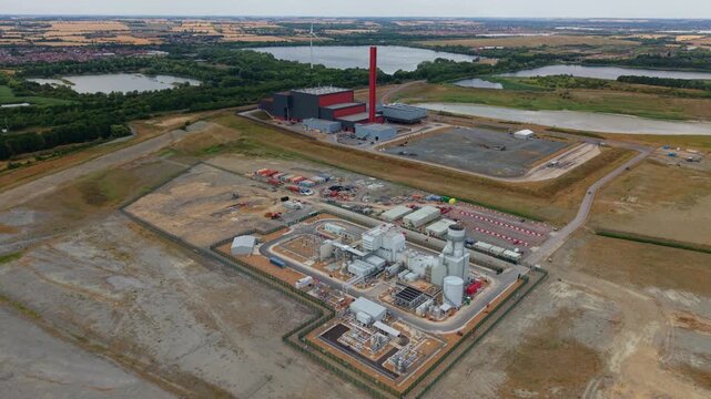 Aerial view of Rookery South ERF and Millbrook power plant with industrial buildings and chimneys set in a rural landscape near Stewartby, England, United Kingdom.