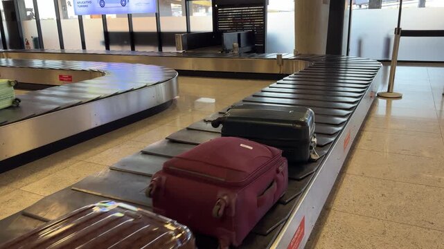 Passenger suitcases moving on a baggage carousel inside Vitória Airport, Brazil