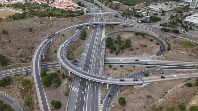 Aerial view of the A5 highway interchange with multi-level roads and surrounding landscape in Cascais, Lisboa, Portugal.