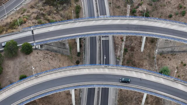 Aerial view of A5 highway interchange with cars driving on curved concrete roads in Cascais, Lisboa, Portugal.