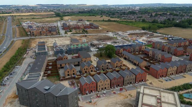 Aerial view of a new residential housing development with rows of brick houses under construction in Luton, England, United Kingdom.