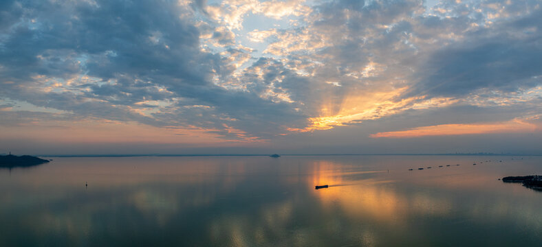 Hefei Chaohu Zhongmiao Sunset Tyndall Light Aerial Photo: Golden Rays Pierce Clouds Over Calm Waters with Solitary Boats at Dusk