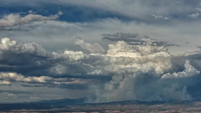 Aerial view of massive pyrocumulus cloud forming from a wildfire over the landscape in Santa Fe, New Mexico, United States.