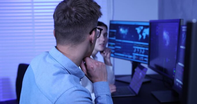 Specialists working with computers in data center, camera moving in