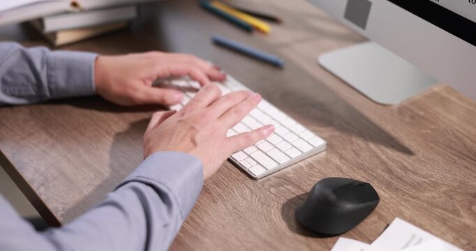Author writing his book on computer at desk in office, closeup