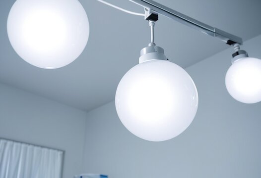Bright modern spherical light bulbs hanging from a minimalist ceiling fixture