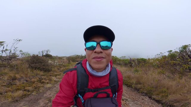 Hiker taking a selfie video in a foggy colombian paramo